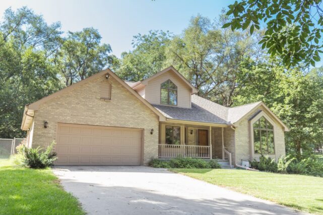 Sturdy, well-maintained suburban home with a focus on foundation integrity, illustrating the benefits of professional foundation repair services for enhancing property value and ensuring long-term structural stability.